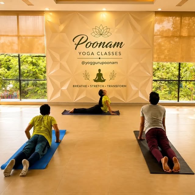 Students practising cobra pose together in the Poonam Yoga Classes studio